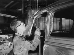 Welder working on body of a car, General Motors, Wellington - Photograph taken by Gordon Onslow Hilbury Burt