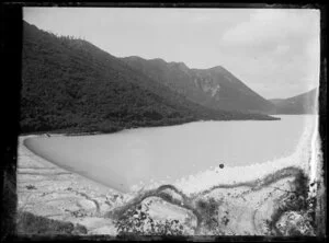 View of a lake, beach, and hills