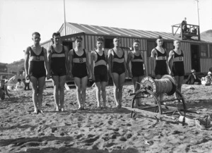 Men of the Island Bay Surf Life Saving Club wearing swimming costumes, including Don Hunter