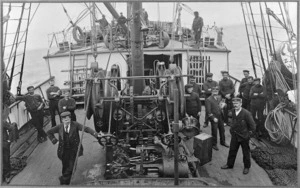 Foredeck of the ship Tutanekai, with sailors alongside the cable winch