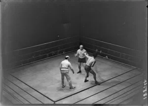 Bare-knuckled boxers & referee [all unidentified] in boxing ring