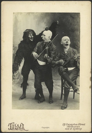 Two clowns playing instruments and a monster - Photograph taken by Talma Studio