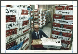 Returning officer Ross Bly with local body voting papers in boxes ready to be posted - Photograph taken by John Nicholson