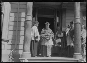 Archbishop Redwood leaving building with entourage