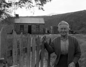 88 year old Mrs H D Ritchie outside her home at the Arrow Bridge, near Arrowtown