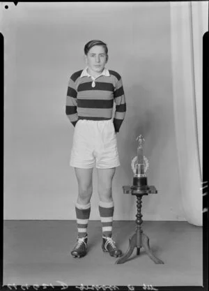 Mr P. Gribble in rugby uniform with trophy