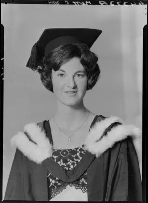 Unidentified young woman in graduation gown, with mortar