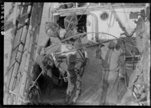 Unidentified men handling cable on deck of Tutanekai