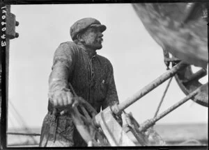 Unidentified man operating machinery on deck of Tutanekai