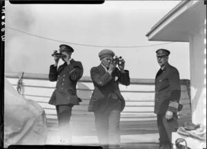 Unidentified men looking through sextants on deck of Tutanekai