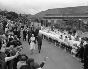 Spectators, including patients moved out into the sunshine, see Her Majesty and His Royal Highness the Duke of Edinburgh, on their visit to the Auckland Hospital