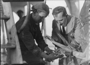 Unidentified men inspecting cut cable on the Tutanekai
