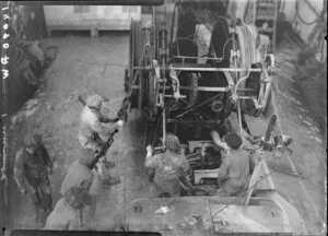 Unidentified men operating machinery on deck of Tutanekai