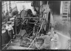 Unidentified men operating machinery on deck of Tutanekai
