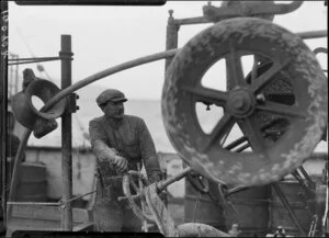 Unidentified men operating machinery on deck of Tutanekai