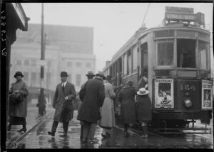 People boarding Lyall Bay tram in rain, Wellington
