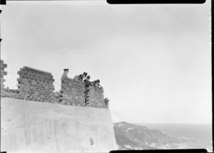 Official party looking over brick wall on parapet, 1926