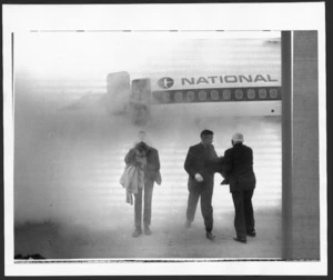 Passengers walking away from a NAC Boeing 737 aircraft in thick smoke, Christchurch Airport