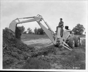 Man operating a Case digger - Photographer unidentified