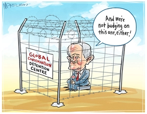 Australian PM Malcolm Turnbull inside a barbed wire pen as he ignores global condemnation of Manus Island detention centre