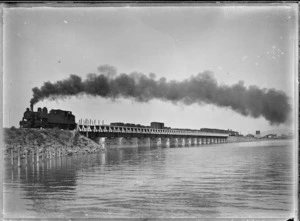 Train hauled by a "Wg" class steam locomotive crossing bridge over Waikareao Estuary, Tauranga