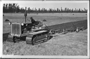 Caterpillar tractor hauling ploughs - Photographer unidentified