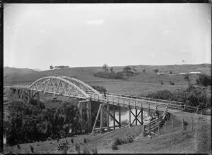 A suspension bridge over an unidentified river, circa 1927