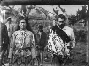 Portrait of three Maori, a man and a woman, with a young boy standing behind