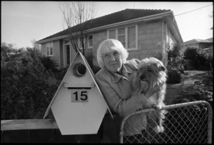 Mrs Zeta Tutt standing at the gate of her State house with her dog Benji, Naenae - Photograph taken by Phil Reid