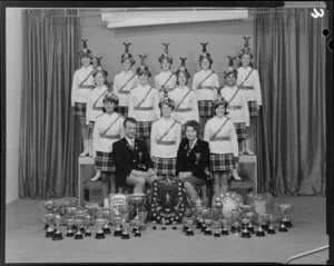 Weldonettes marching team with numerous cups and shields including New Zealand Marching Association Quick March Trophy