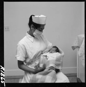 Maori nurse holding a Maori baby, Te Puia Hospital, East Coast - Photograph taken by Gregor Riethmaier