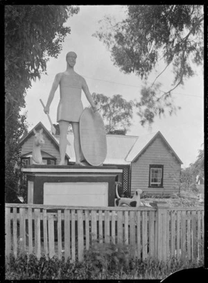 Front view of "Rose Cottage", Moroa, near Greytown, with a statue of an ancient warrior standing on a pedestal in front of the house.