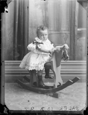 Toddler of the Salek family on a rocking horse