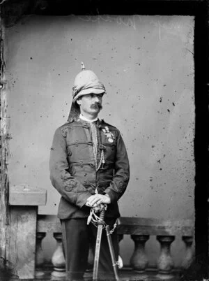 Major Noake, with peaked helmet, sabre and medals