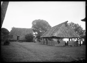 Scene showing buildings with thatched roofs, probably Fiji