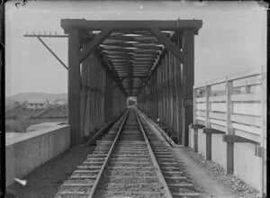 View along railway tracks and over bridge crossing the Whanganui River at Aramoho