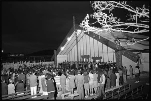 Crowd gathered around the meeting house at the dawn opening of Pipitea Marae, Thorndon Quay, Wellington