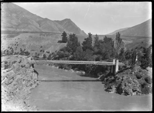 Suspension bridge over a fairly wide river, probably in the Otago region, circa 1926.