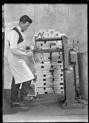 Unidentified railway employee using an electric rivetter at the Hillside Railway Workshops, 1926