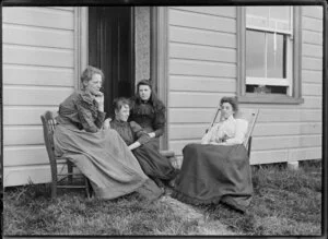 Four unidentified young women seated at the door to Daniel Manders Beere's house, location of house unknown