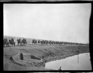 Mounted soldiers riding along the embankment of the Suez Canal