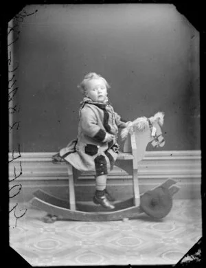 Goff infant on rocking horse