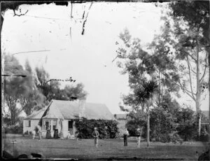 Single-storied wooden house with people outside, Wanganui