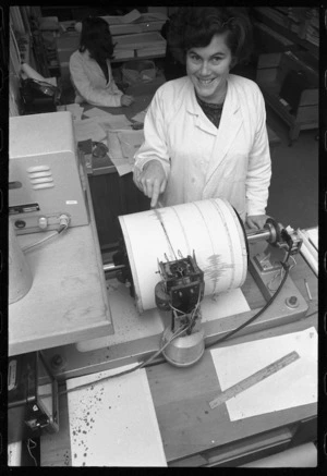 Technician Mrs C E Lock with a visual seismograph, Seismological Observatory, Wellington