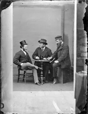 Three unidentified men playing a game with dice