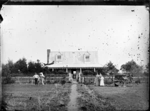 Half a storied house with verandah, people standing on other side of picket fence and horse buggy