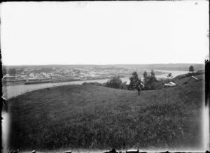 View of Taupo Quay and central Whanganui for Durie Vale. A man and child can be seen on the hill in the foreground