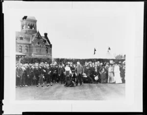 Large group of men and women watching an unidentified woman bowl, bowling club, St Kilda, Melbourne