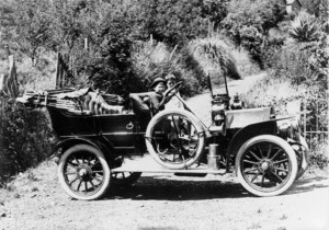 Young boy behind the steering wheel of a car