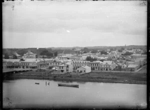 View of Taupo Quay and central Whanganui from the eastern bank of the river. The end of Victoria Avenue bridge can be seen
